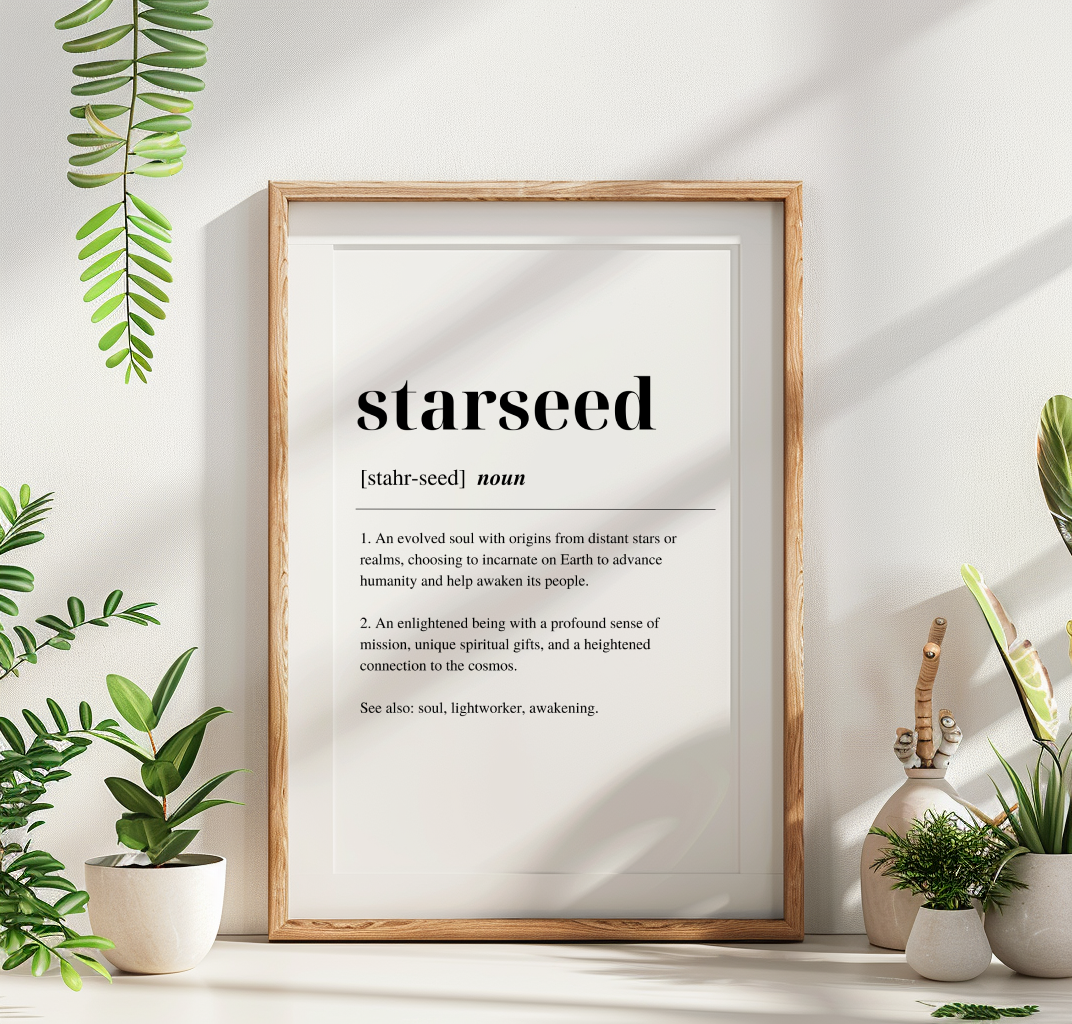 A digital art print with the word 'Starseed' written on it with a definition, displayed in a wooden frame , on a mantlepiece accompanied by a vase with plants surrounding.